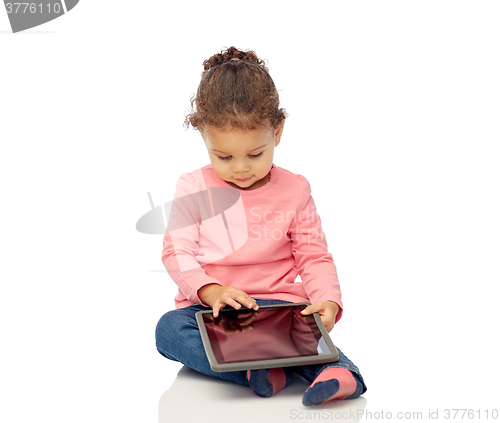 Image of little baby girl playing with tablet pc computer