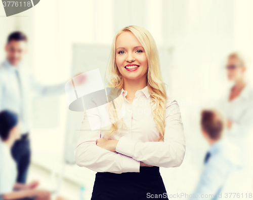 Image of smiling businesswoman or secretary in office