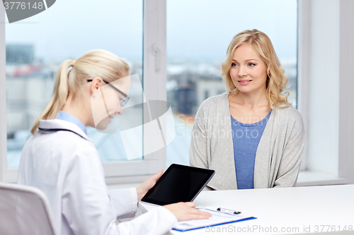 Image of doctor with tablet pc and woman at hospital