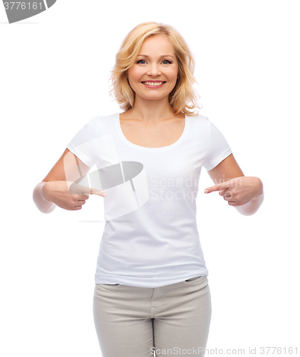 Image of smiling woman in white t-shirt pointing to herself