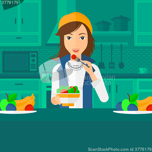Image of Woman eating salad.