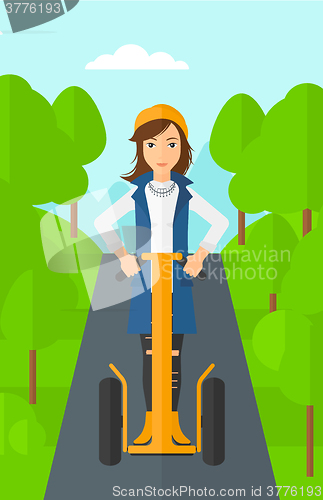 Image of Woman riding on electric scooter.