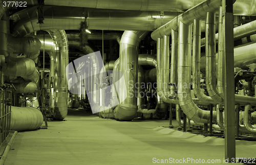 Image of Pipes and tubes and chimney at a power plant