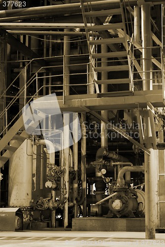 Image of Pipes and tubes and chimney at a power plant