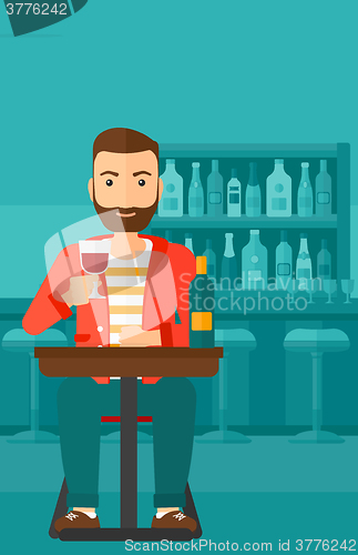 Image of Man sitting at bar.