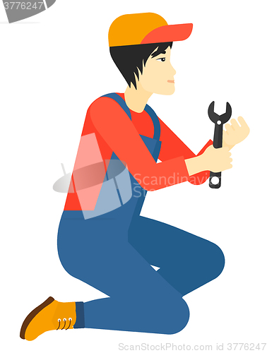 Image of Repairman holding spanner.