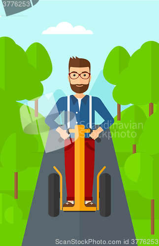 Image of Man riding on electric scooter.