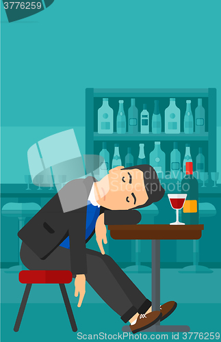 Image of Man sleeping in bar. 