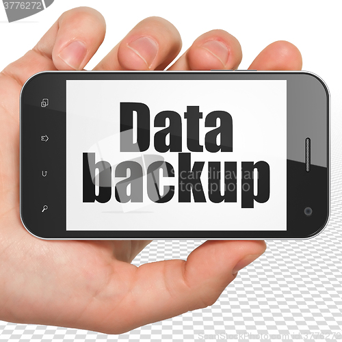 Image of Information concept: Hand Holding Smartphone with Data Backup on display