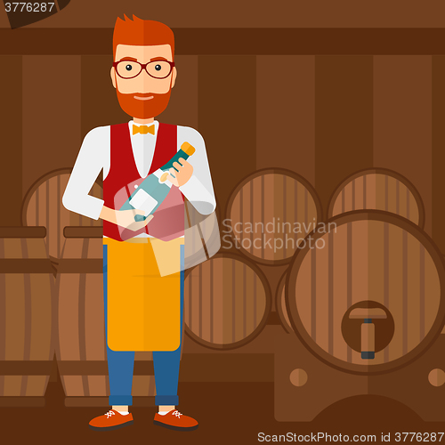 Image of Waiter holding bottle of wine.