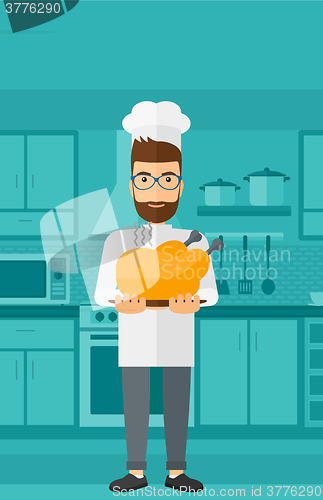 Image of Man holding roasted chicken.