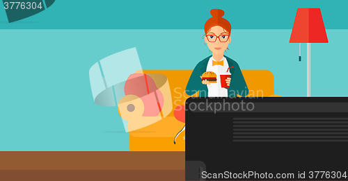 Image of Woman eating hamburger. 