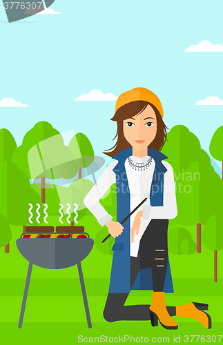 Image of Woman preparing barbecue.