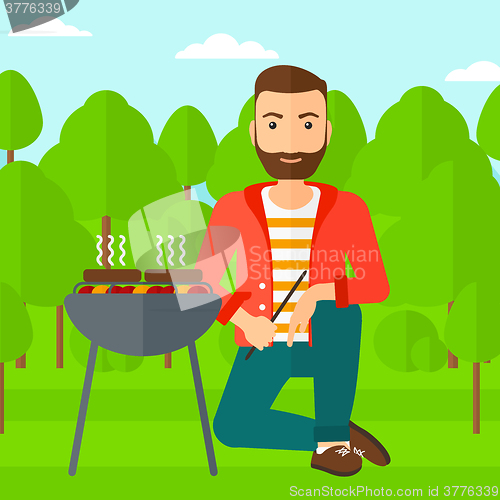 Image of Man preparing barbecue.