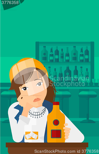 Image of Sad man with bottle and glass.
