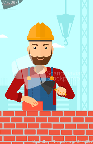 Image of Bricklayer with spatula and brick.