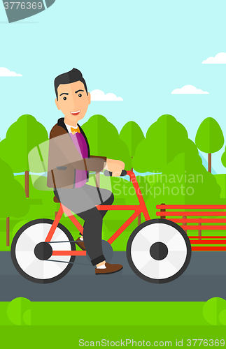 Image of Man riding bicycle.