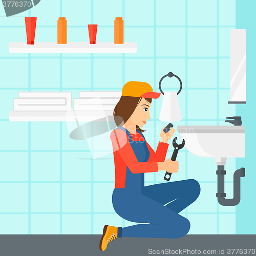 Image of Woman repairing sink.