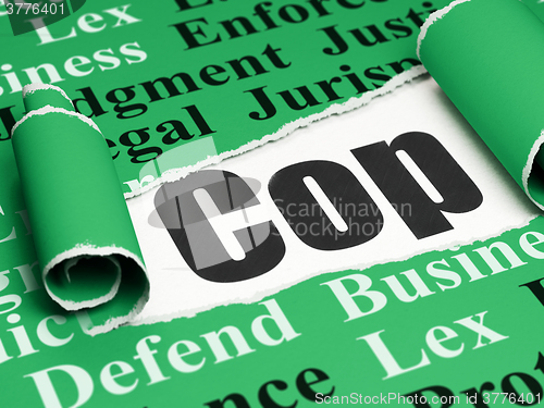 Image of Law concept: black text Cop under the piece of  torn paper