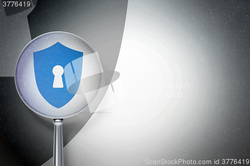 Image of Privacy concept:  Shield With Keyhole with optical glass on digital background