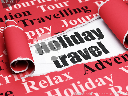 Image of Vacation concept: black text Holiday Travel under the piece of  torn paper