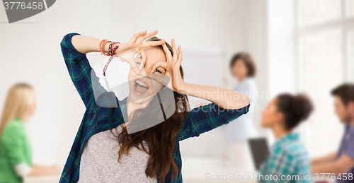 Image of happy student girl making face at school