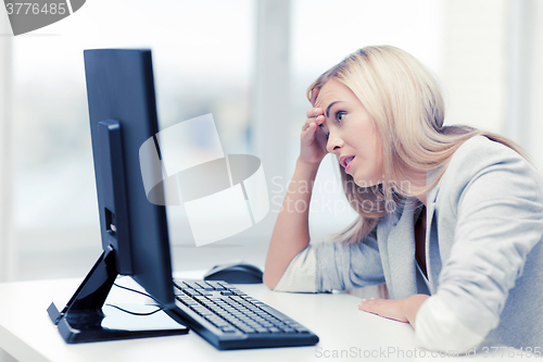 Image of stressed woman with computer