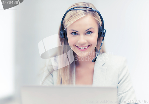 Image of friendly female helpline operator with laptop