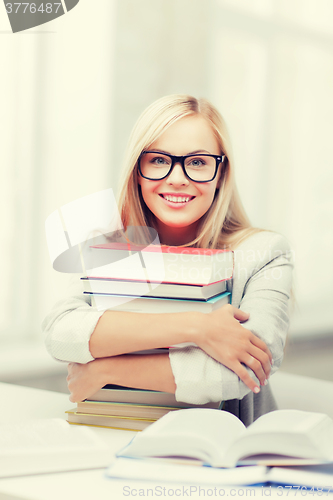 Image of student with stack of books