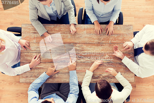 Image of close up of business team sitting at table