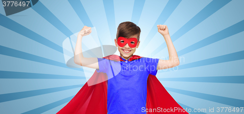 Image of boy in red super hero cape and mask showing fists