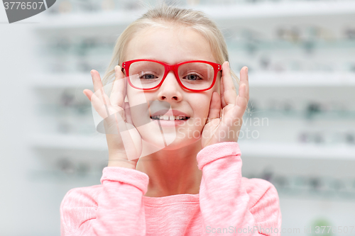 Image of little girl in glasses at optics store