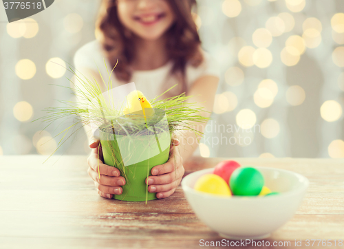 Image of close up of girl holding pot with easter grass