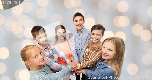 Image of happy children with hands on top