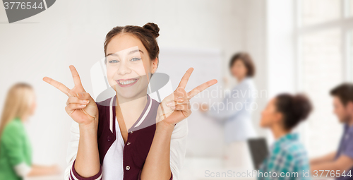Image of teenage student girl showing peace at school