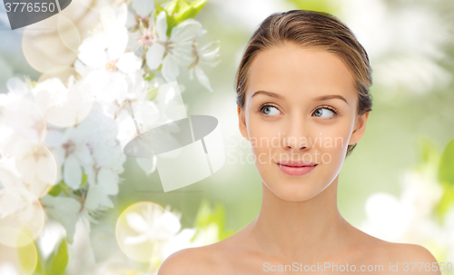 Image of smiling young woman face and shoulders