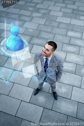 Image of young smiling businessman outdoors from top