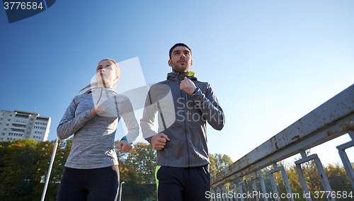 Image of couple running outdoors