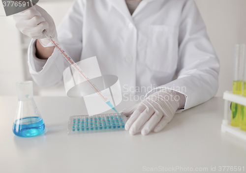 Image of close up of scientist making test in lab