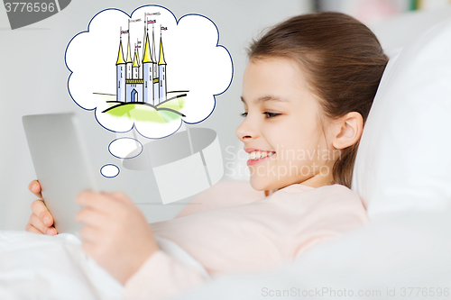 Image of happy girl with tablet pc dreaming of fairy castle