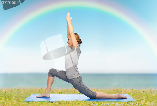 Image of happy woman making yoga in low lunge on mat