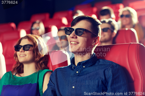 Image of happy friends watching movie in 3d theater