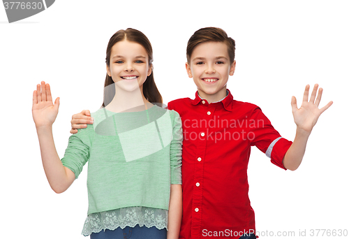 Image of happy boy and girl waving hand