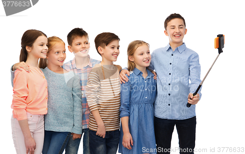 Image of happy children with smartphone and selfie stick