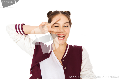 Image of happy smiling teenage girl showing peace sign