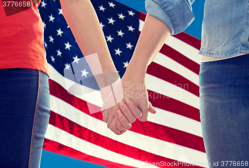 Image of close up of lesbian couple holding hands