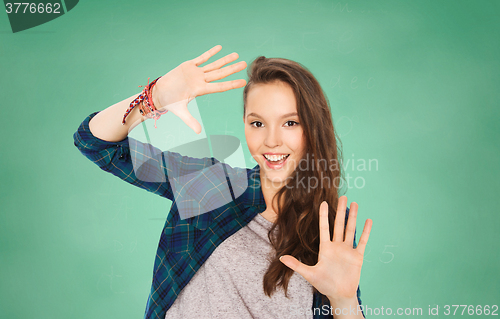 Image of happy smiling student teenage girl showing hands