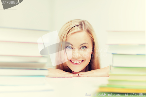 Image of student with stack of books