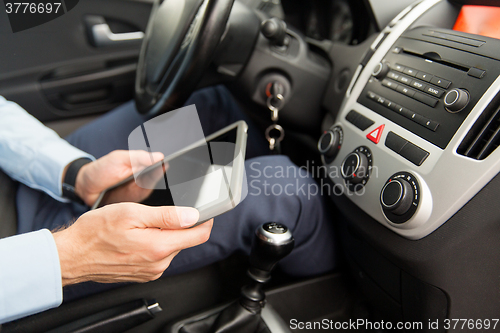 Image of close up of young man with tablet pc driving car