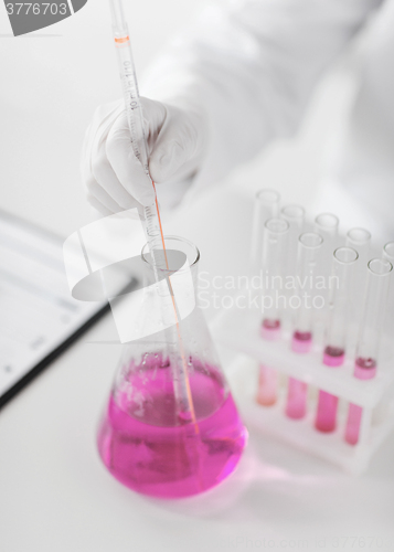 Image of close up of scientist making test in lab